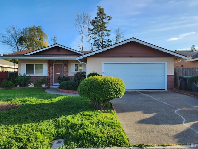 ranch-style house featuring a front yard, fence, an attached garage, concrete driveway, and brick siding