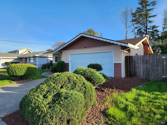 view of front of home with fence and a garage