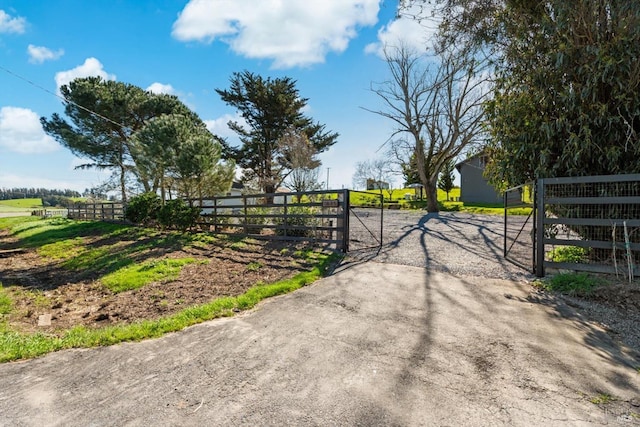 view of gate featuring a rural view and fence