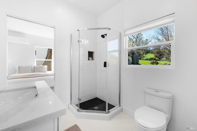 bathroom with a shower stall and toilet