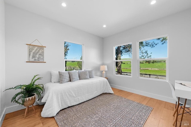 bedroom featuring recessed lighting, baseboards, and light wood finished floors