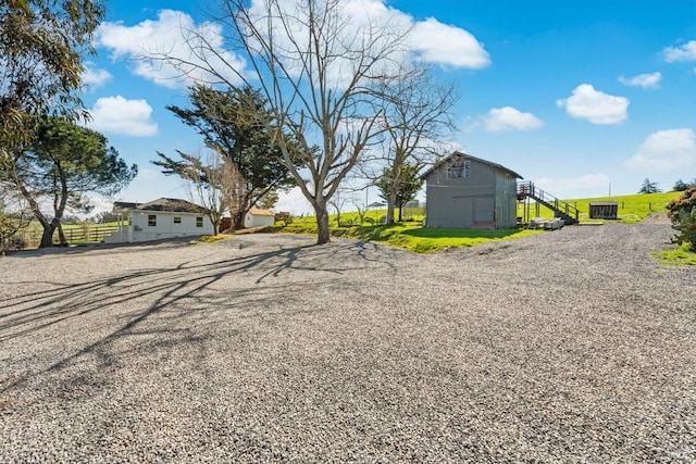 view of street featuring a barn and driveway