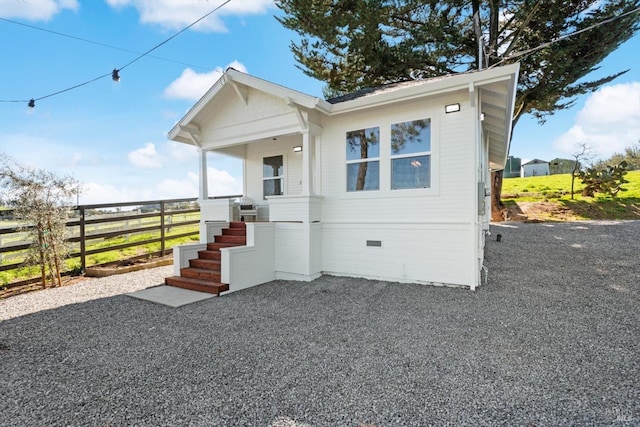 bungalow-style home with crawl space and fence