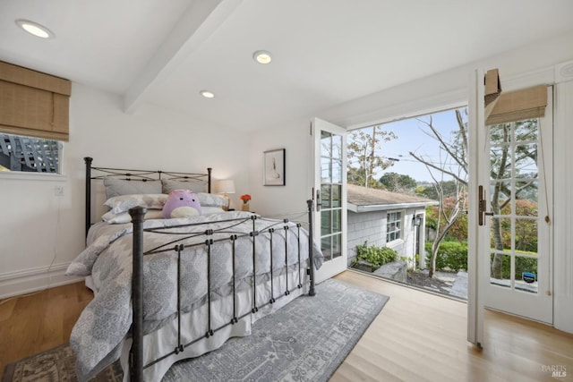 bedroom featuring beam ceiling, recessed lighting, wood finished floors, and access to outside