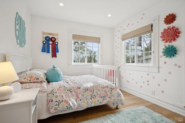 bedroom with recessed lighting, baseboards, and wood finished floors