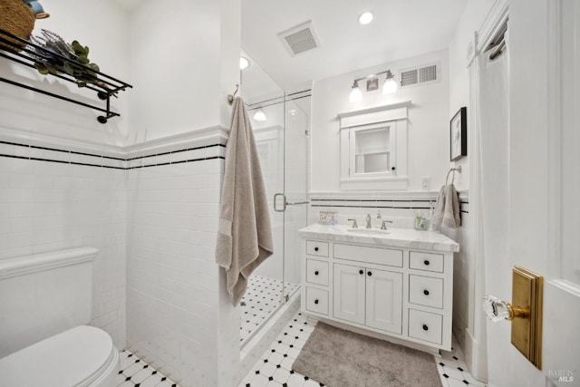 full bath featuring visible vents, vanity, toilet, and a shower stall