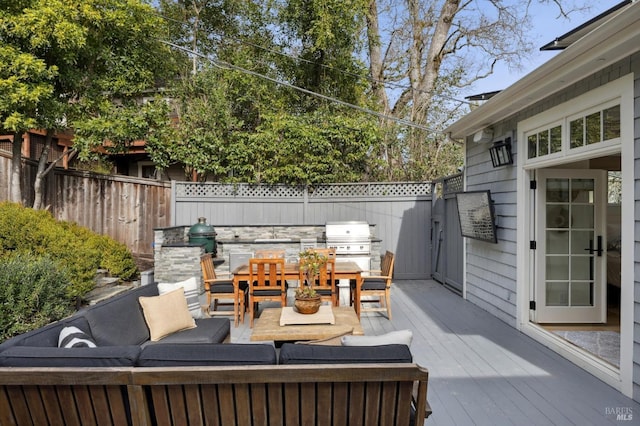 view of patio with outdoor lounge area, a grill, fence, and a wooden deck