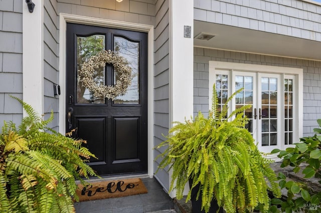 entrance to property featuring visible vents and french doors