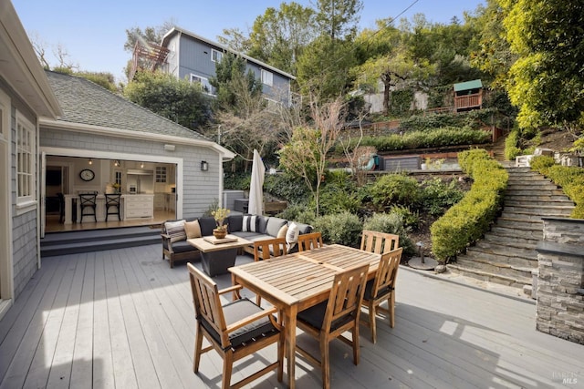 wooden terrace featuring outdoor dining space and an outdoor hangout area