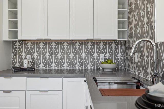 kitchen with backsplash, white cabinets, and open shelves