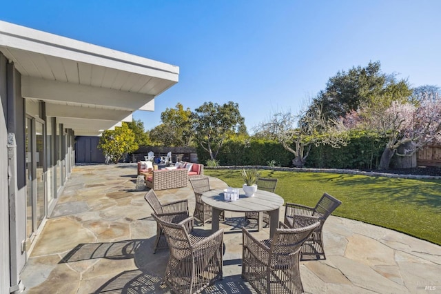 view of patio / terrace featuring an outdoor living space, a fenced backyard, and outdoor dining space