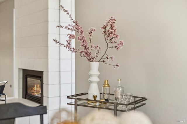 interior details with a glass covered fireplace