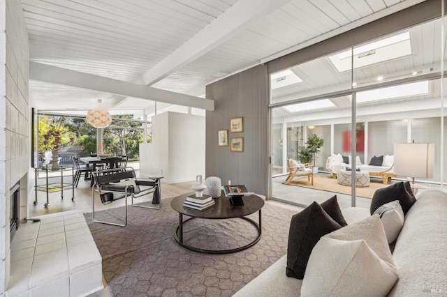 living area featuring beamed ceiling and expansive windows