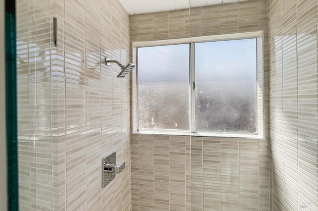 bathroom with a tile shower