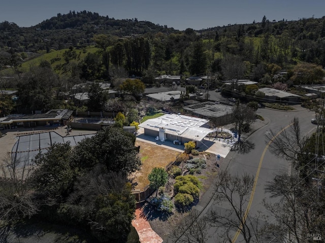 drone / aerial view featuring a wooded view