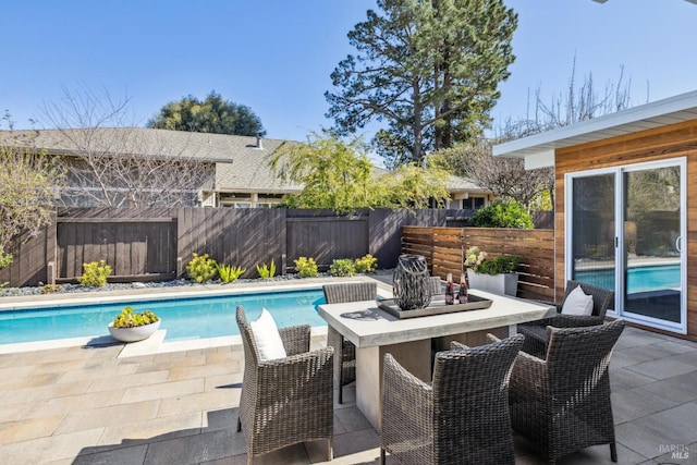 view of pool with a patio area, a fenced in pool, outdoor dry bar, and a fenced backyard