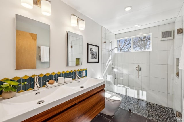 bathroom featuring visible vents, a shower stall, toilet, and double vanity