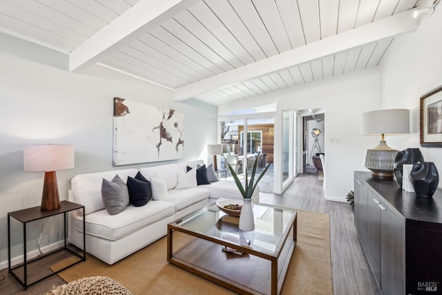 living room featuring lofted ceiling with beams, baseboards, wood ceiling, and wood finished floors