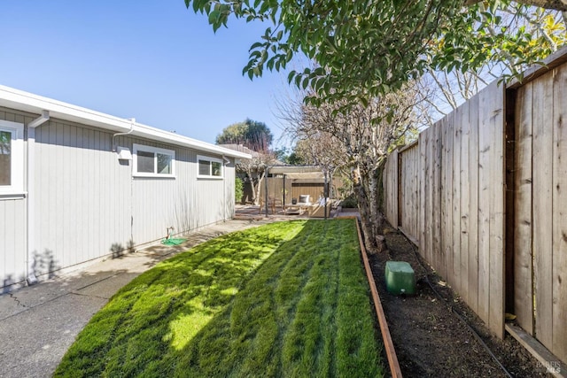 view of yard featuring a patio area and a fenced backyard