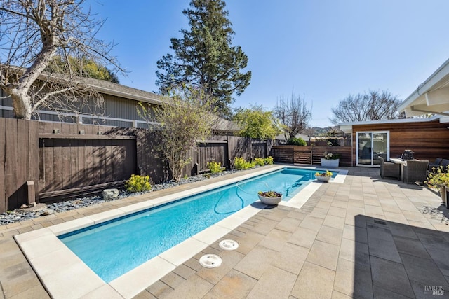 view of pool with a patio area, a fenced in pool, and a fenced backyard