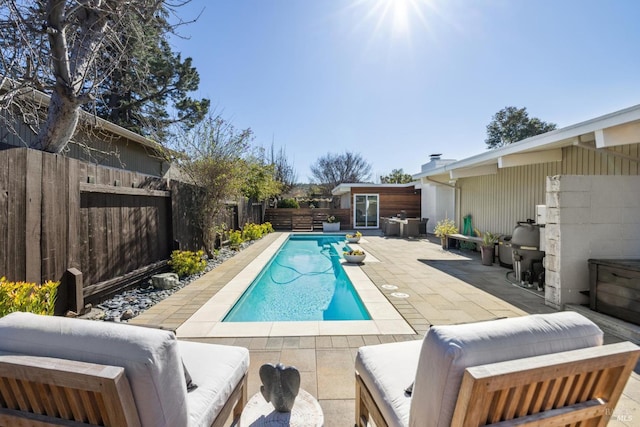 view of pool featuring a fenced backyard, a grill, outdoor lounge area, a fenced in pool, and a patio area