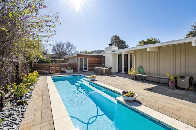 view of pool featuring a fenced in pool, fence, and a patio area