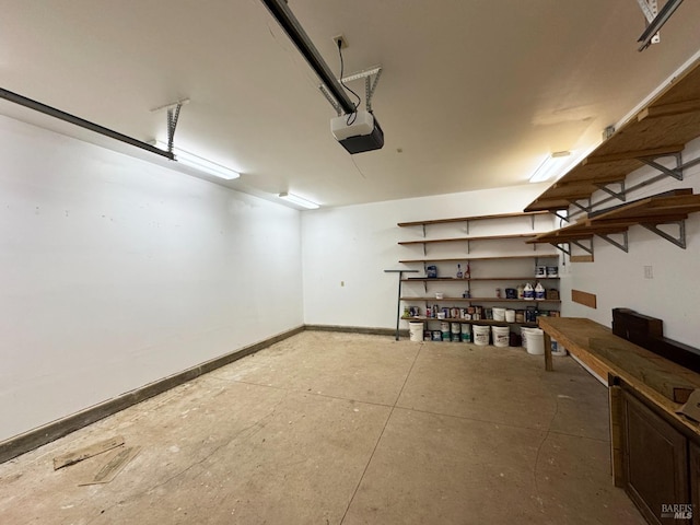 garage with a garage door opener and baseboards