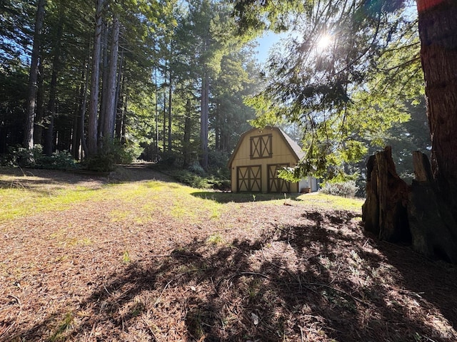 view of yard with a barn and an outdoor structure