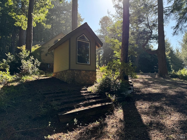 view of side of home with stone siding