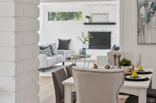 living area featuring wood finished floors and a fireplace