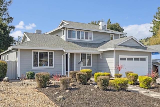 view of front of home featuring an attached garage, a chimney, and a shingled roof