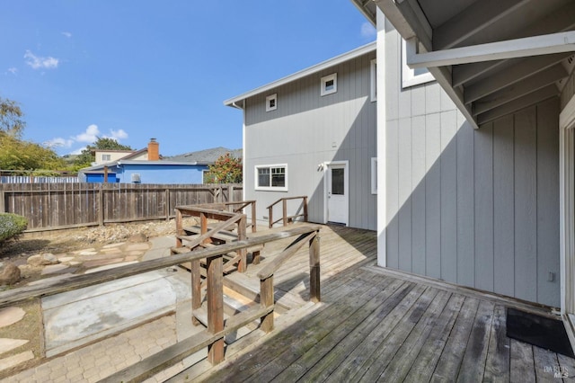 deck with outdoor dining space and fence