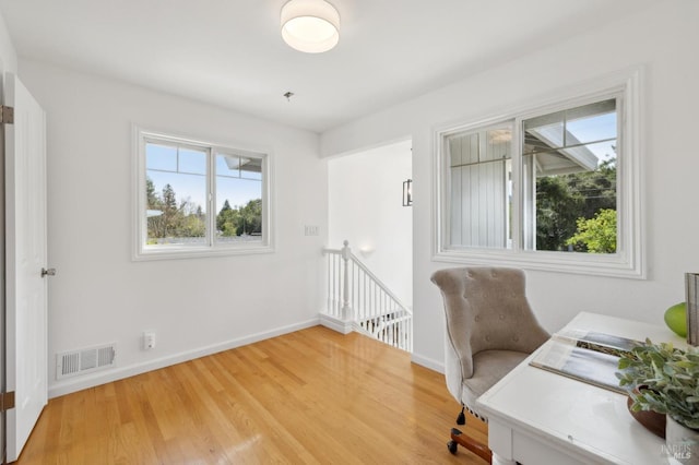 office space with visible vents, baseboards, and wood finished floors