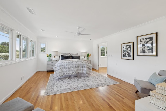 bedroom with multiple windows, light wood-style flooring, and ornamental molding