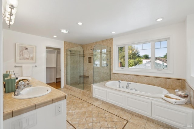 bathroom featuring a sink, a garden tub, recessed lighting, and a shower stall