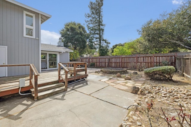 view of patio featuring a deck and a fenced backyard