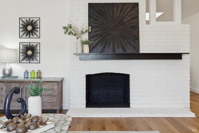 interior details with wood finished floors and a fireplace