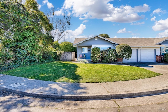 view of front facade featuring brick siding, fence, a front yard, a garage, and driveway