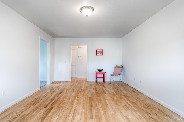 unfurnished room featuring light wood finished floors and baseboards