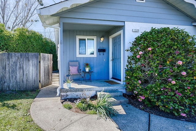 view of exterior entry featuring fence