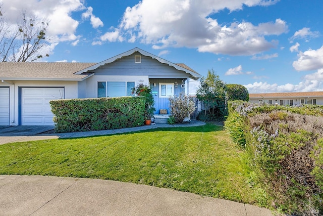 view of front of home with an attached garage, a shingled roof, driveway, and a front yard