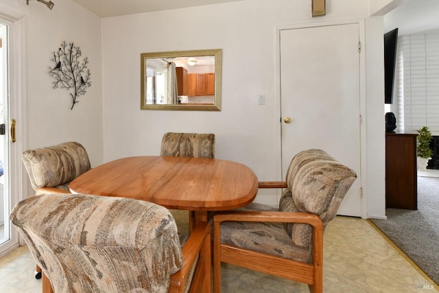 dining area with light colored carpet