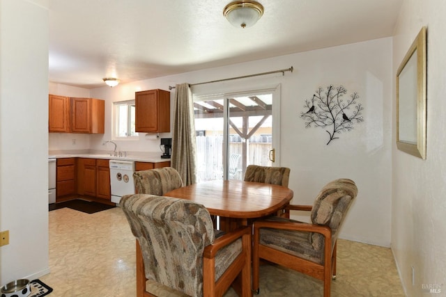 dining space featuring baseboards and light floors