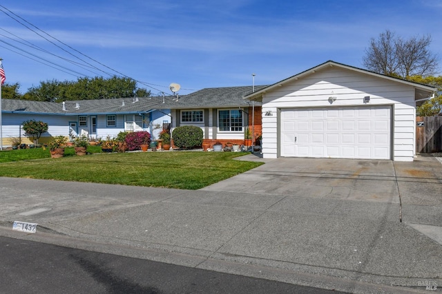 single story home with driveway, an attached garage, and a front lawn