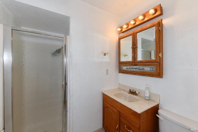 full bath with vanity, toilet, and a stall shower