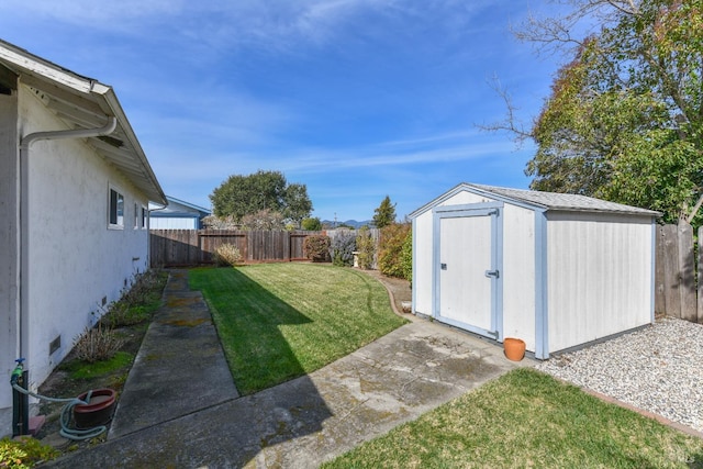 view of yard with a fenced backyard, a storage shed, and an outdoor structure