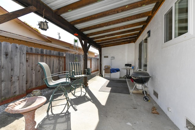 view of patio with visible vents, area for grilling, and fence