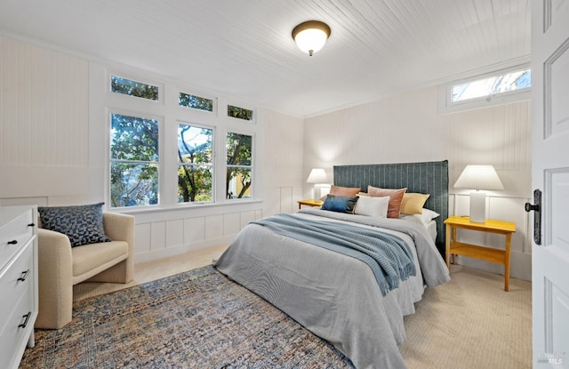 bedroom featuring light colored carpet and crown molding