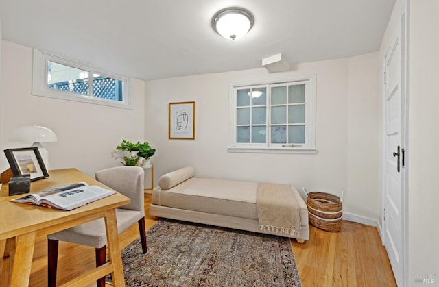 office area featuring baseboards and light wood finished floors