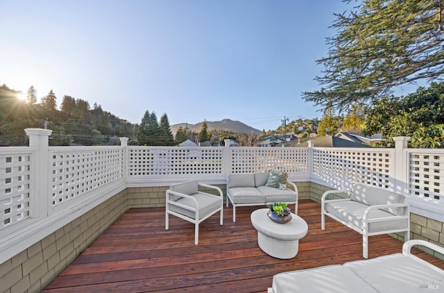 deck featuring a mountain view and outdoor lounge area